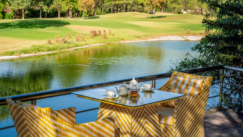 a table set for two with a view of the lake