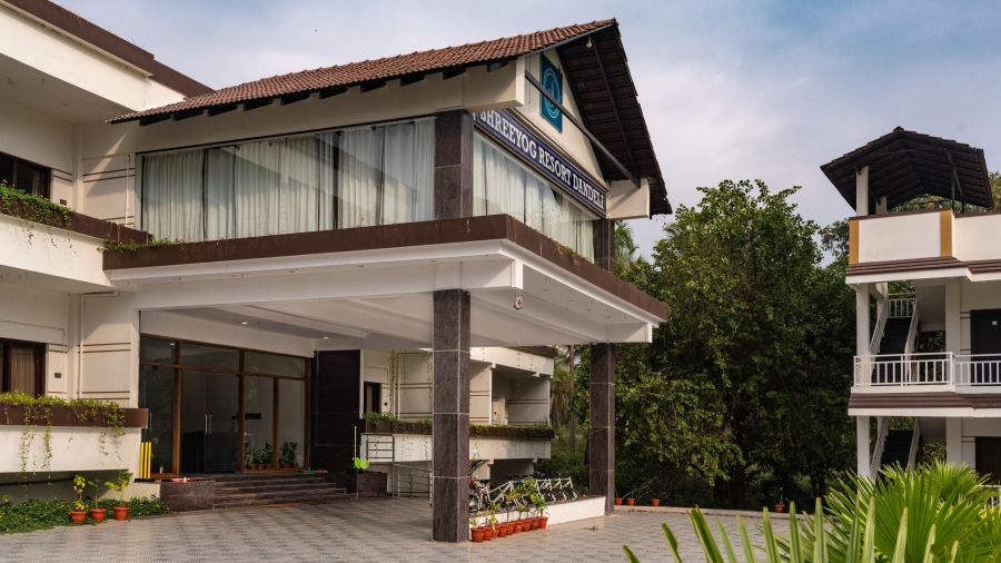 The entrace of Mastiff Select Shreeyog Resort with potted plants in view