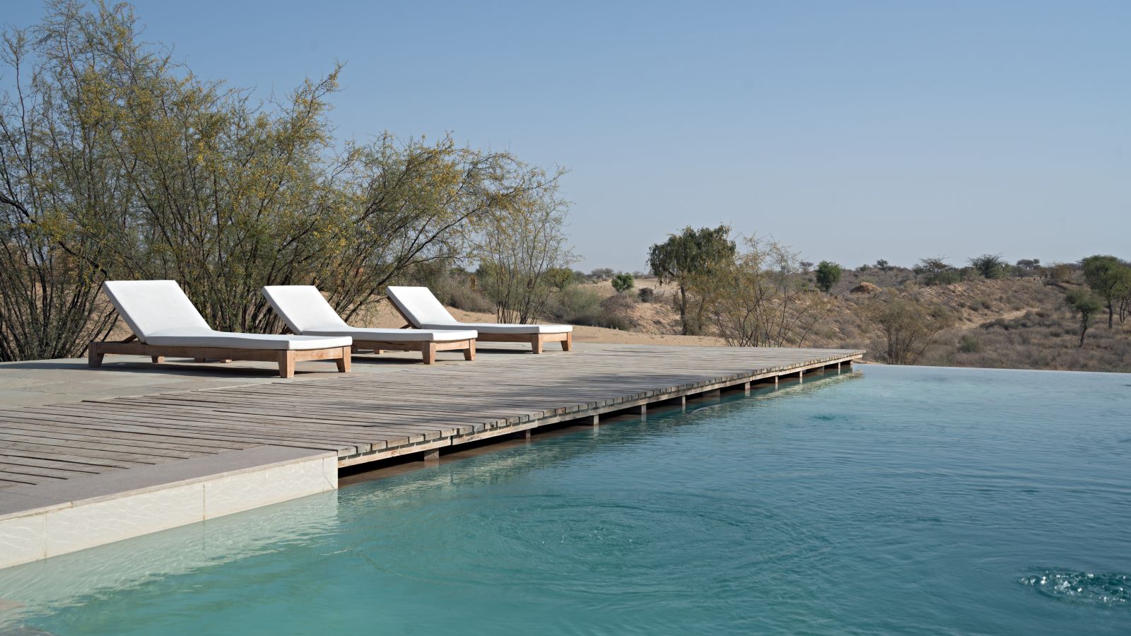 Lounging chairs set besides a swimming pool