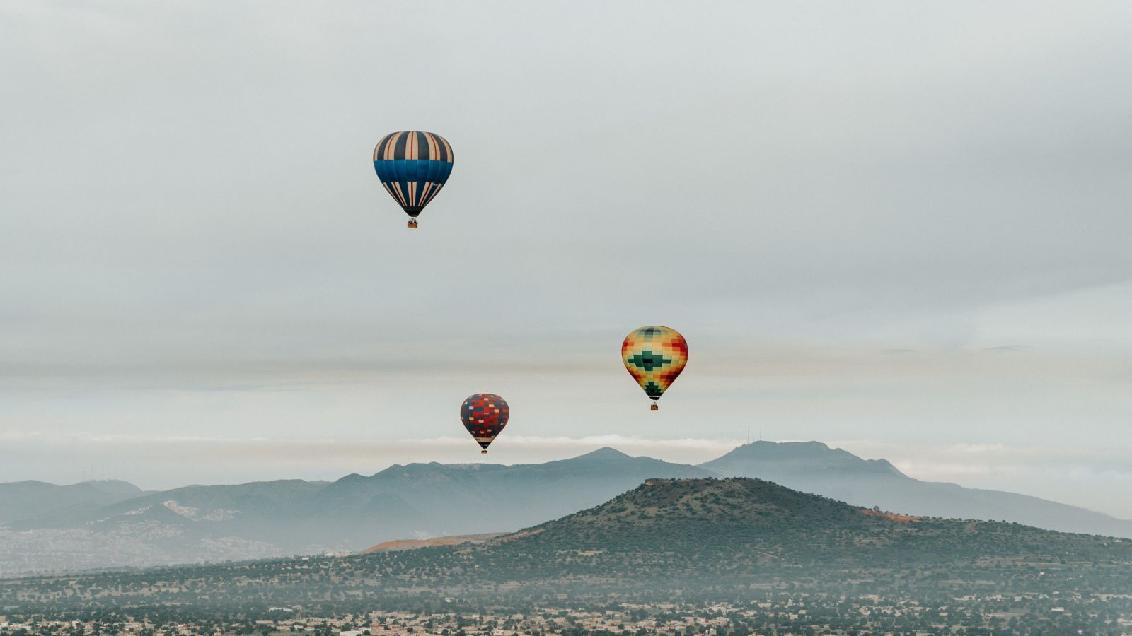 three hot air balloons in the sky