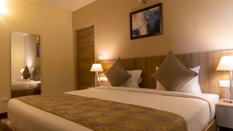 A double bed inside Deluxe One Bedroom Suite - Starlit Suites, Tirupati