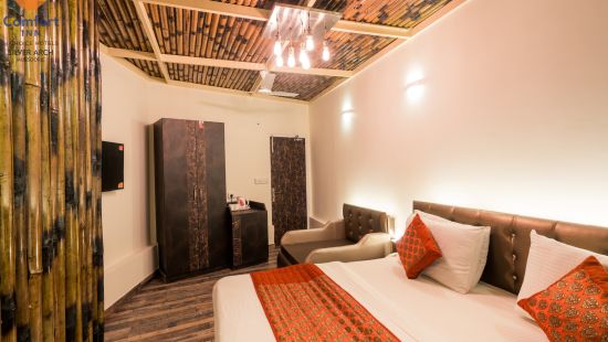 Bamboo Cottage decked with bed, wardrobe and television with bamboo interior at Comfort Inn Silver Arch, Mussoorie