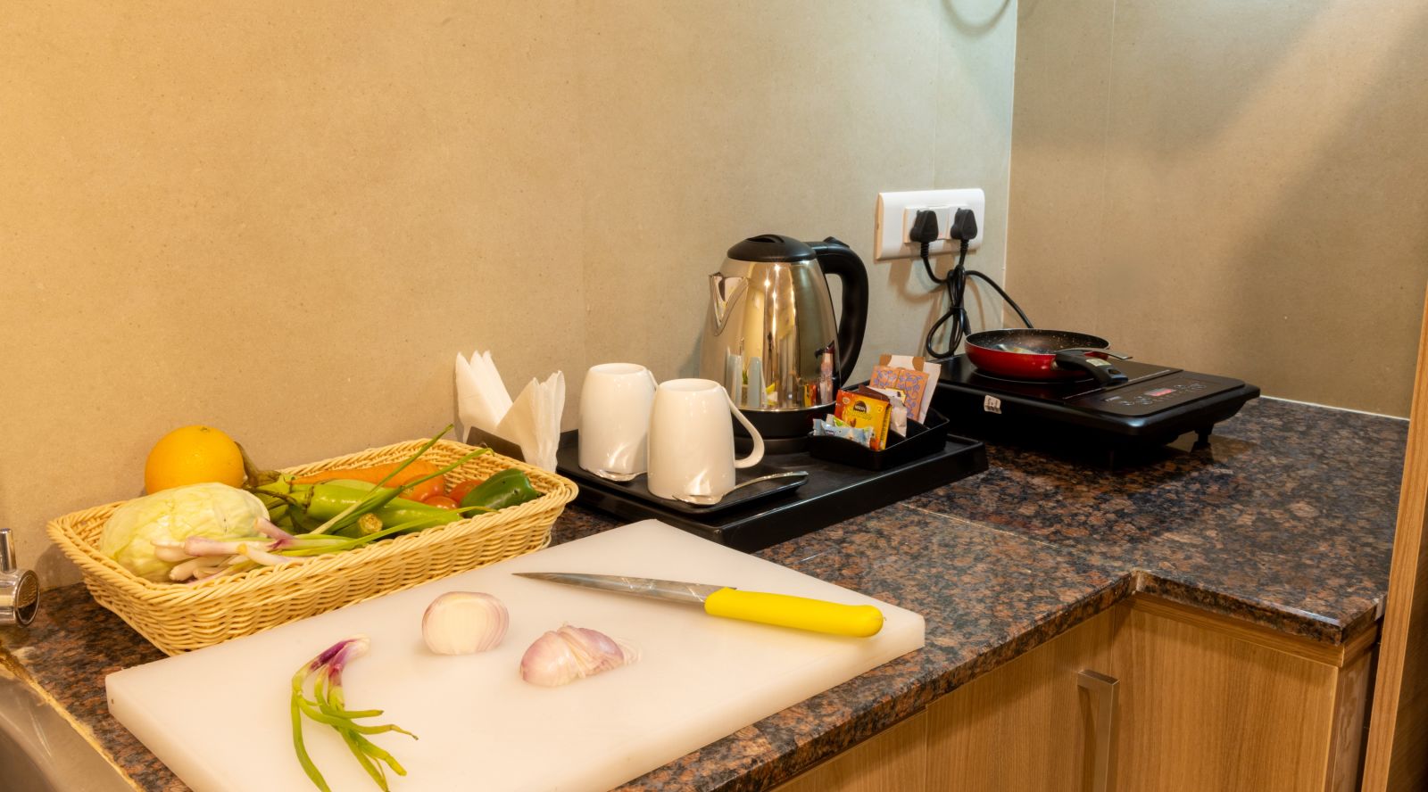 A close up shot of the things on the kitchen counter inside Premium Two Bedroom Suite - Starlit Suites, Tirupati