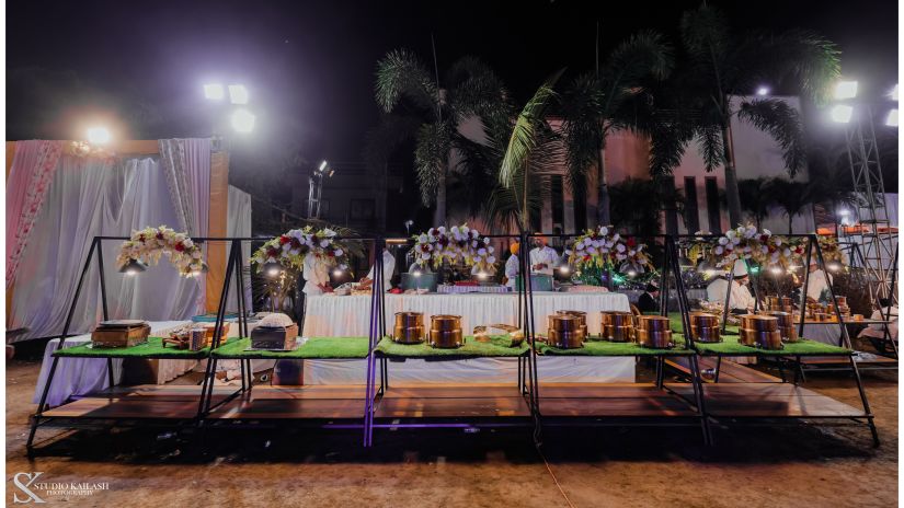 Small boxes neatly arranged on a triangular-shaped table structure in the outdoor venue.