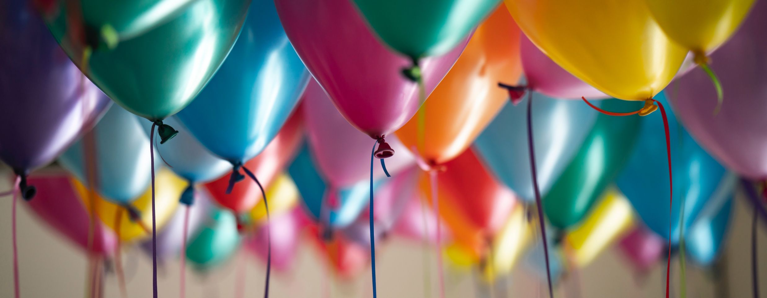 Colourful balloons stuck to the ceiling - birthday celebration in Goa