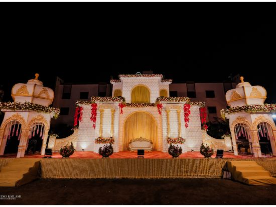 A podium adorned with castle-like structures stands against a backdrop, creating a regal setting for what appears to be a wedding.