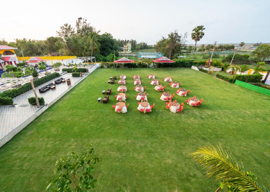 alt-text The event lawn with tables and chairs at our hotel in Mandarmani - Viceroy Beach and Spa Resort, Mandarmani