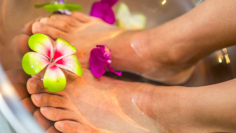 dipped feet in water depicting a spa pedicure