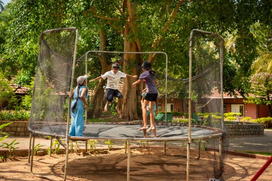 alt-text KIDS jumping in the TRAMPOLINE  - Ibex River Resort, Pollachi