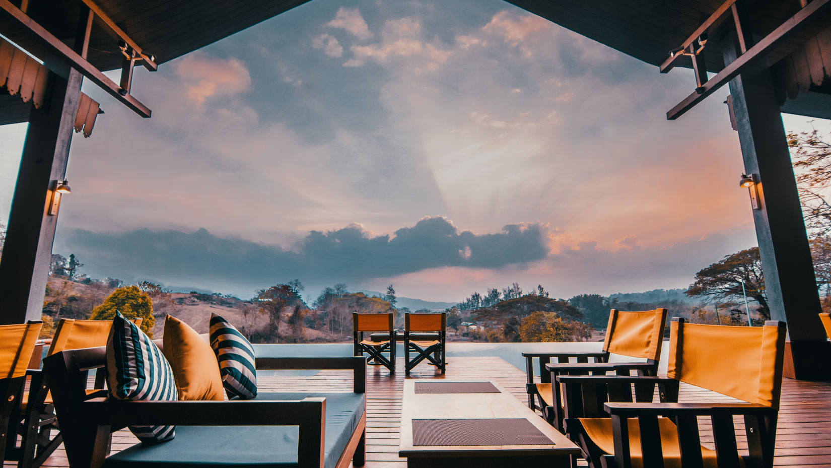 Multi-colured chairs overlooking a vibrant sky - Symphony Samudra Beachside Jungle Resort And Spa, Port Blair