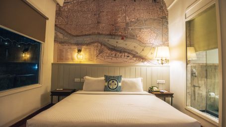 Elegant bedroom with white bedding and vintage map decor