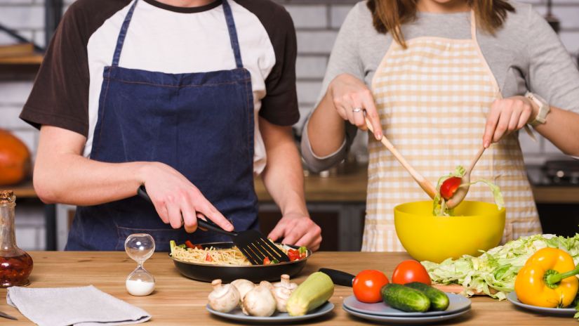 image of a couple mixing vegetables 