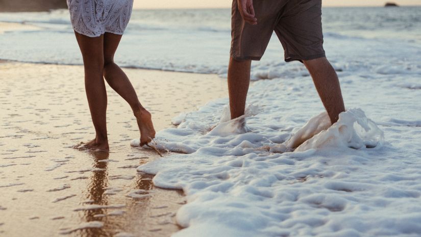 couple walking on the beach at our honeymoon resort in Goa