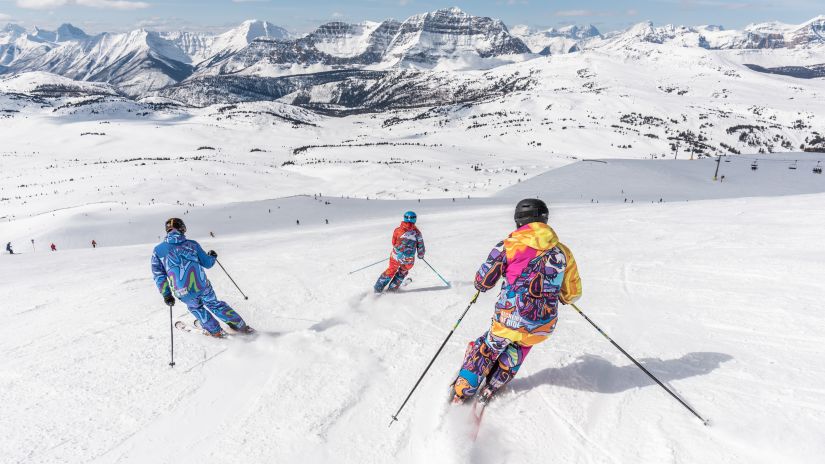 People skiing in snow downhill a mountain