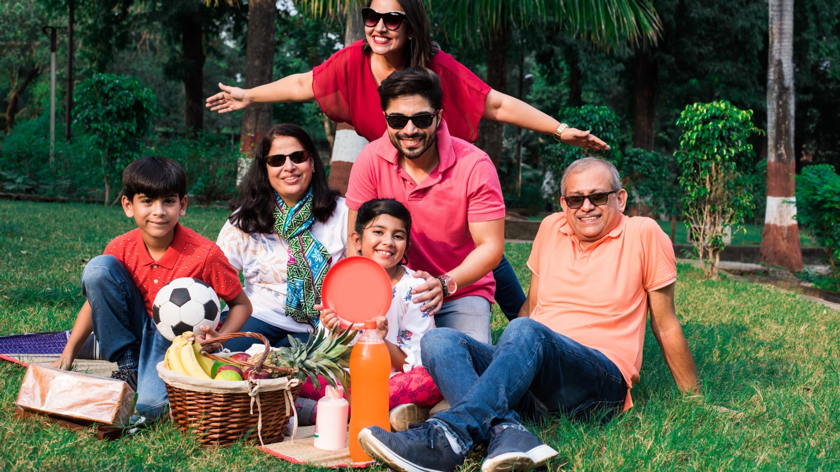 a family posing for the camera at a picnic 2