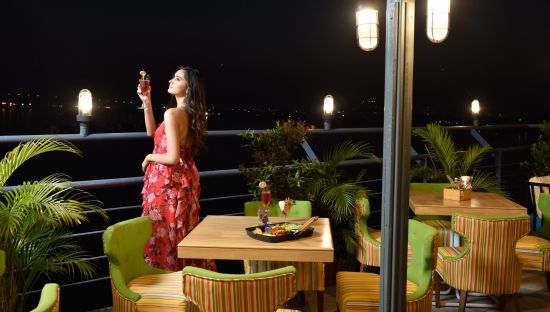 alt-text a girl looking at stars from the outside deck  - polo floatel kolkata