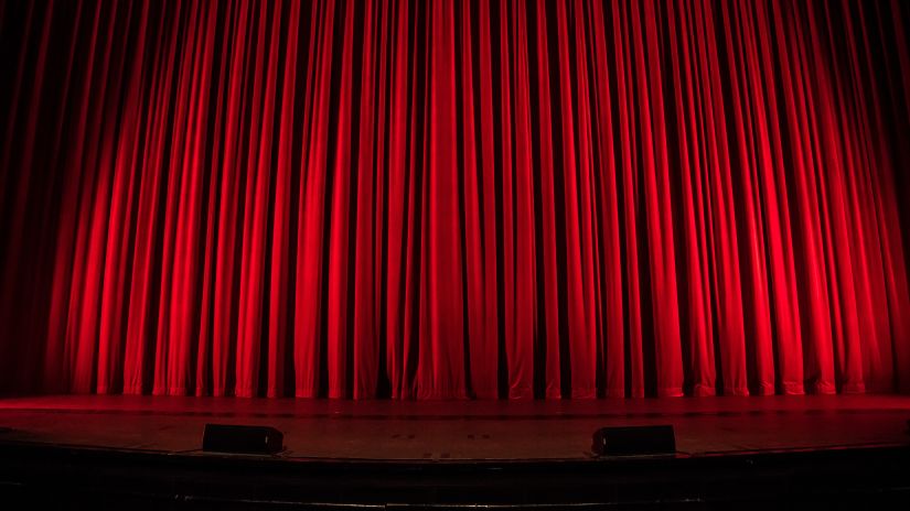 red curtain in front of a stage