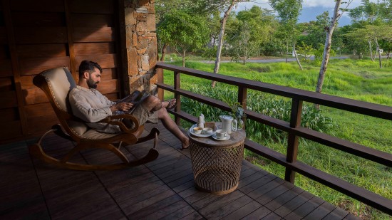 a person reading a magazine outdoors at The Serai Bandipur