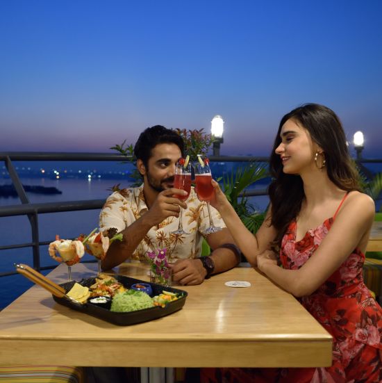 a couple having a dinner date at the outdoor seating area of the restaurant - polo floatel kolkata