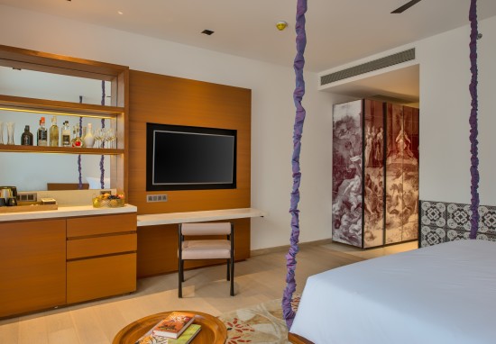 alt-text Hotel room with television, furniture and a private bar