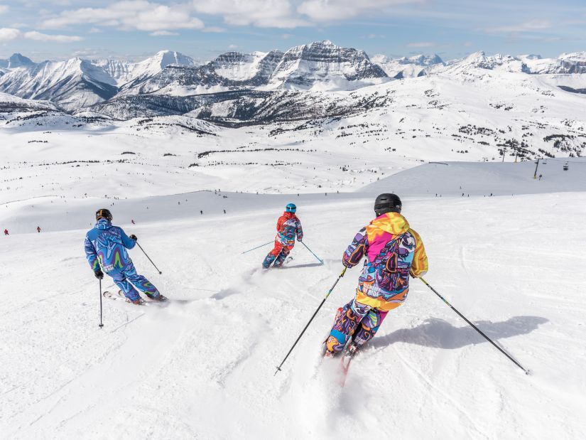 People skiing in snow downhill a mountain