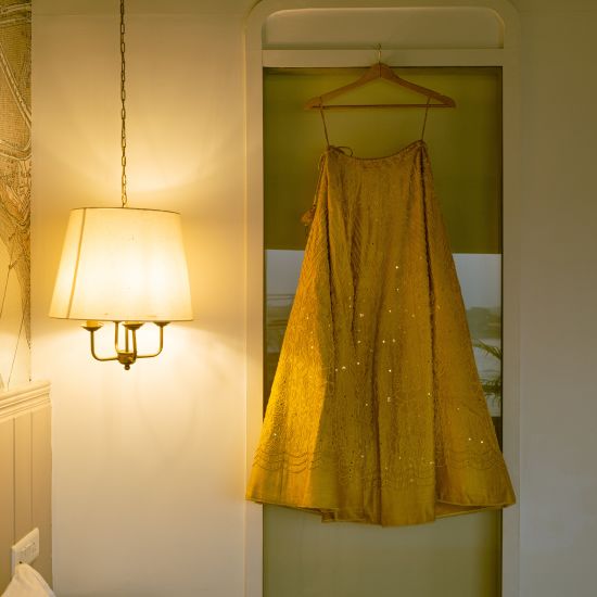 a yellow coloured room with a dress hanging from a hanger - polo floatel kolkata