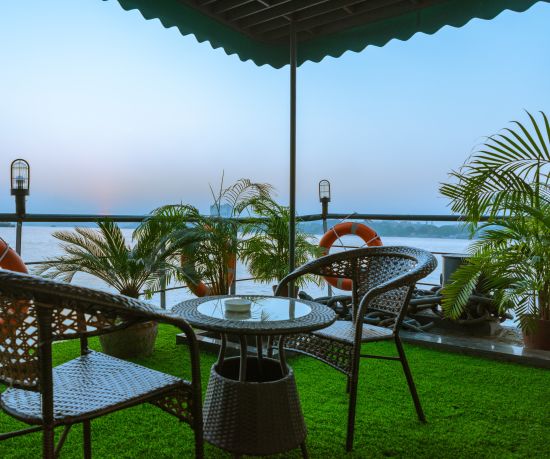 alt-text a seat for two on the outside deck overlooking river hooghly - polo floatel kolkata