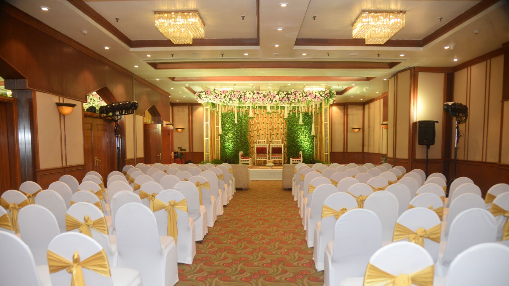 Indoor wedding section decorated with flowers and lighting at The Orchid Hotel Mumbai Vile Parle