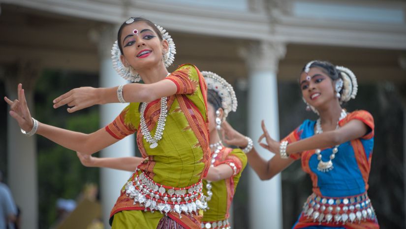 three girls performing traditional Indian dance