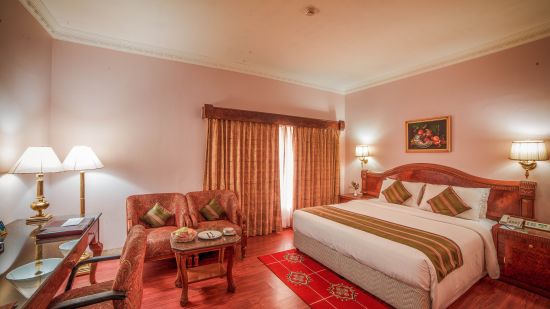 a double bed inside one of the Rooms at Raj Park Hotel in Alwarpet, Chennai