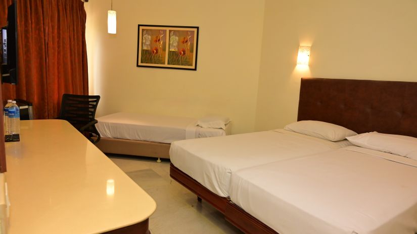 Side view of Suite with large bed, desk and other basic amenities - View of Standard Room for double occupancy with plush bed and basic amenities - Jayaram Hotel, Pondicherry