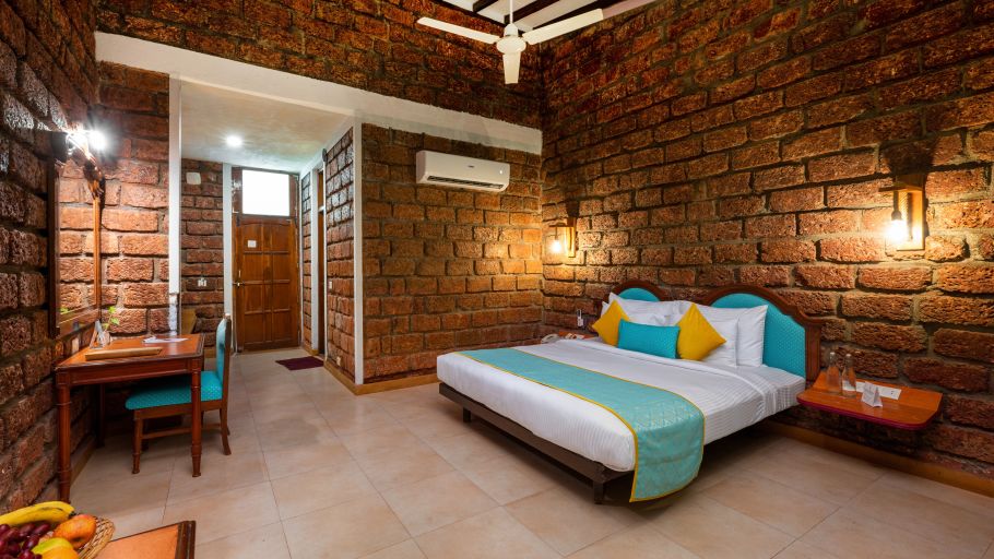 Lotus eco beach resort, king size bed with study table on the side at Sea Breeze Suite