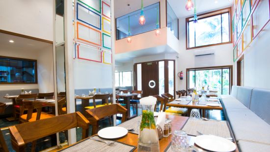 seatings arrangements inside the restaurant with plates kept on the table