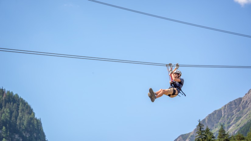 a child ziplining during daytime