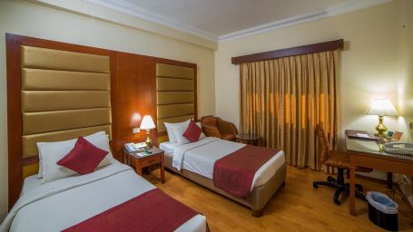 twin beds in a bedroom at Deluxe Roomat  Raj Park Hotel, Chennai