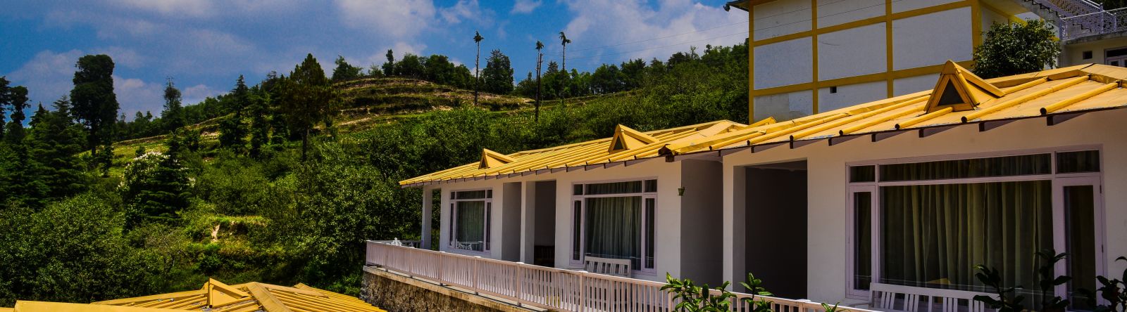 A exterior view of the Te Aroha by Shervani, Mukteshwar with mountain backdrop