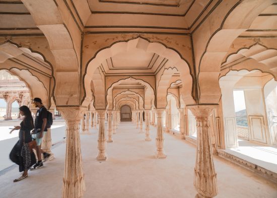 alt-text a couple roaming around an arch-shaped temple ground