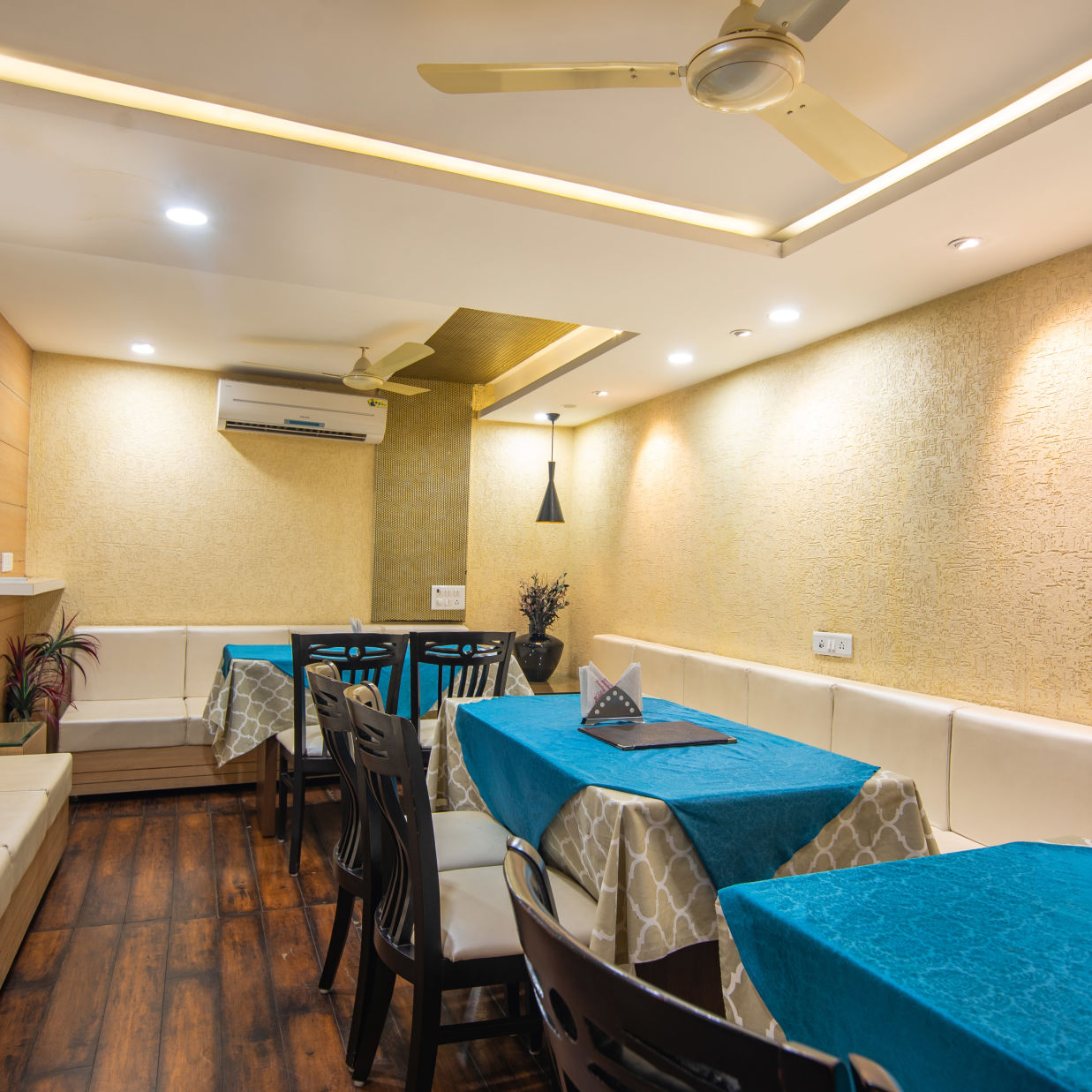 a dining area featuring a bunch of tables and chairs - Morya Regency, Bhopal