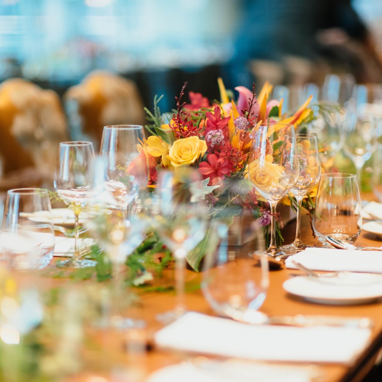 A table with fancy cutlery, glass bottles and decorations during an event