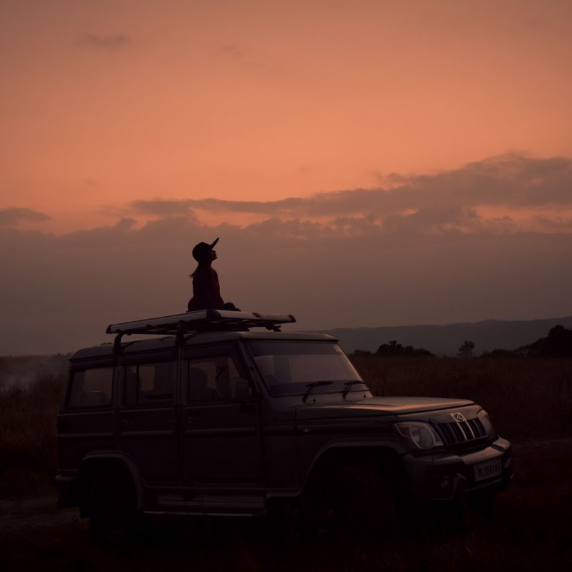 a person peeking through the sun roof of a car