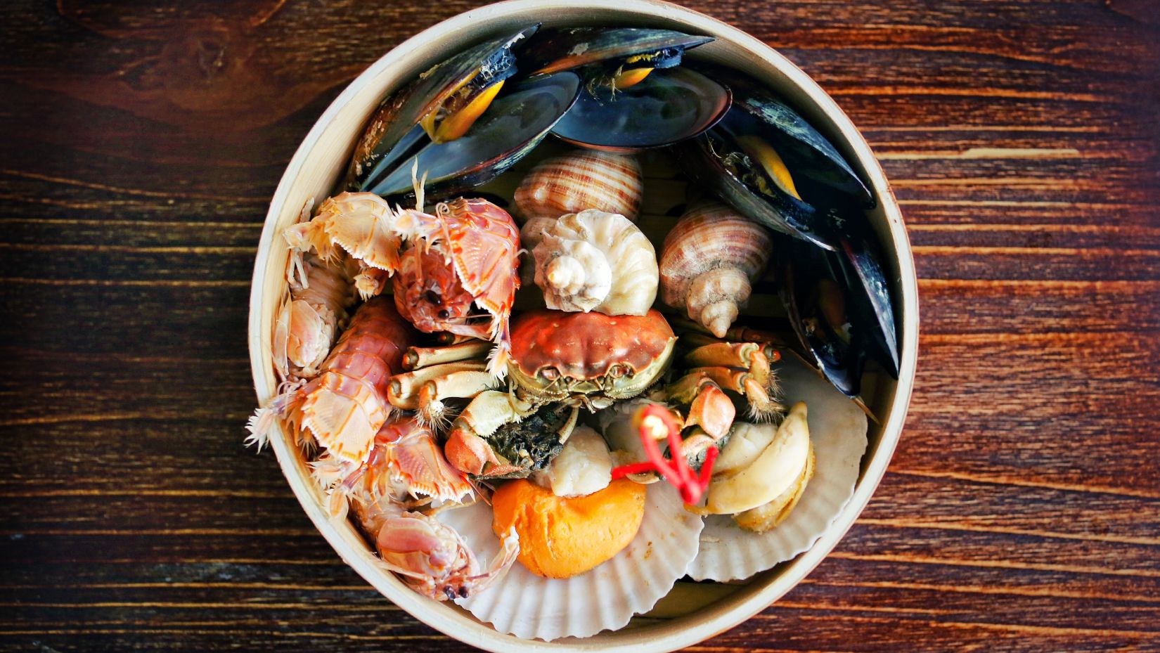 a bowl served with various seafood