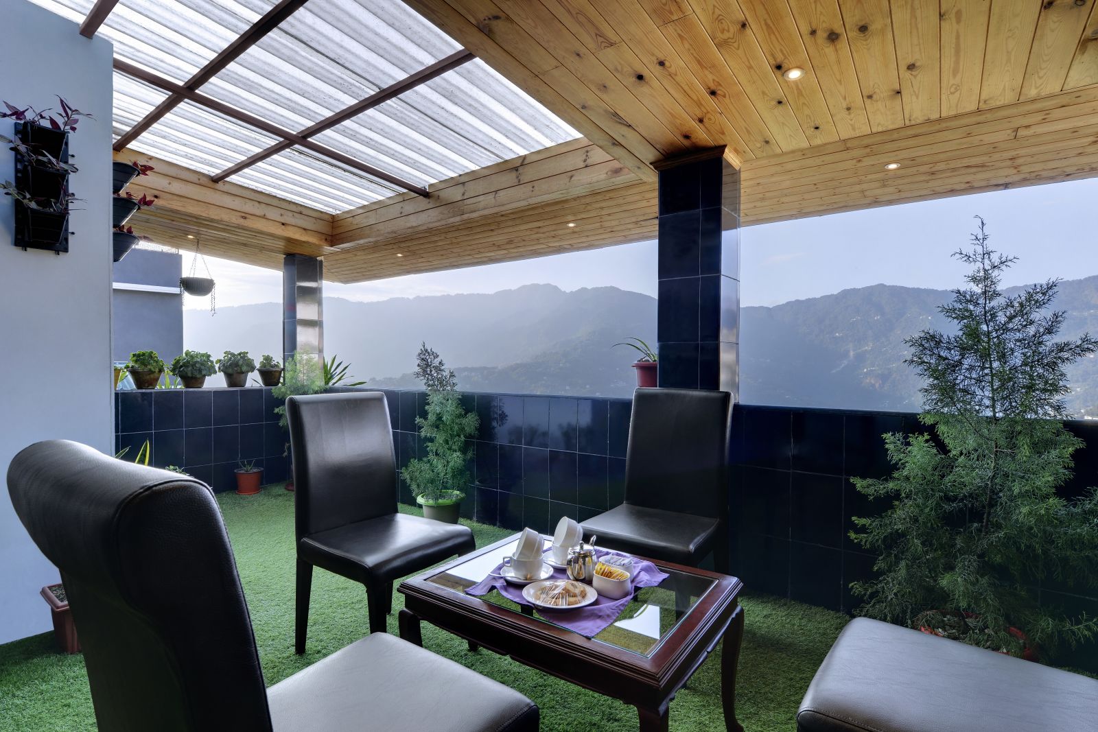 seating arrangements in an outdoor area with grass on the floor - Sumitel Shangrila, Deorali