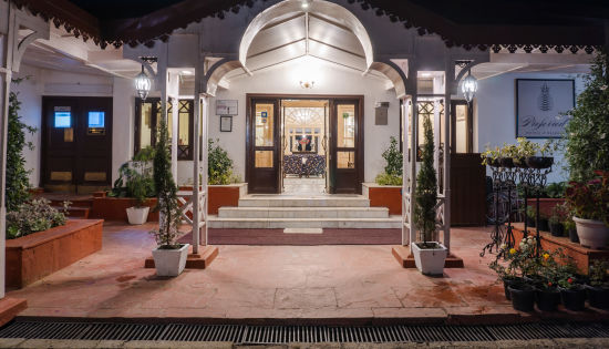 alt-text  A close-up view of The Claridges Nabha Residence's facade in Mussoorie, captured at night