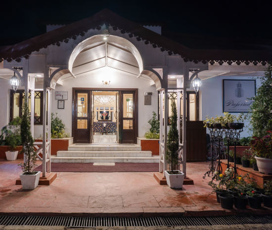 alt-text  A close-up view of The Claridges Nabha Residence's facade in Mussoorie, captured at night