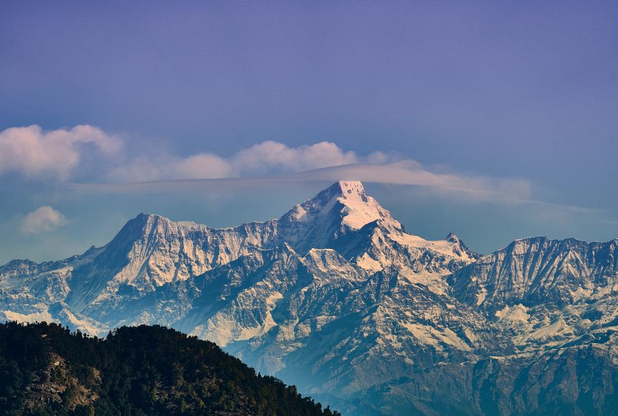 alt-text snow covered mountains with clear blue sky above