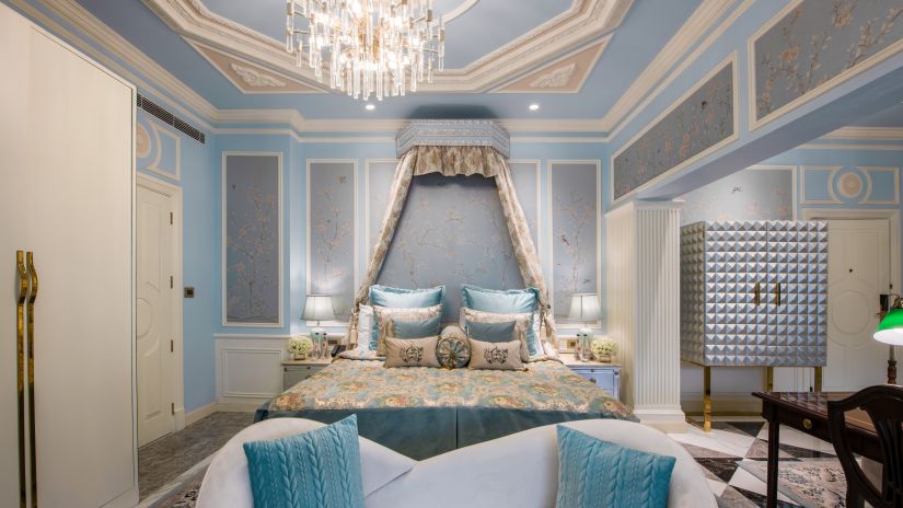 front view of a bedroom with sofas for sitting and a chandelier - The Claridges, New Delhi 