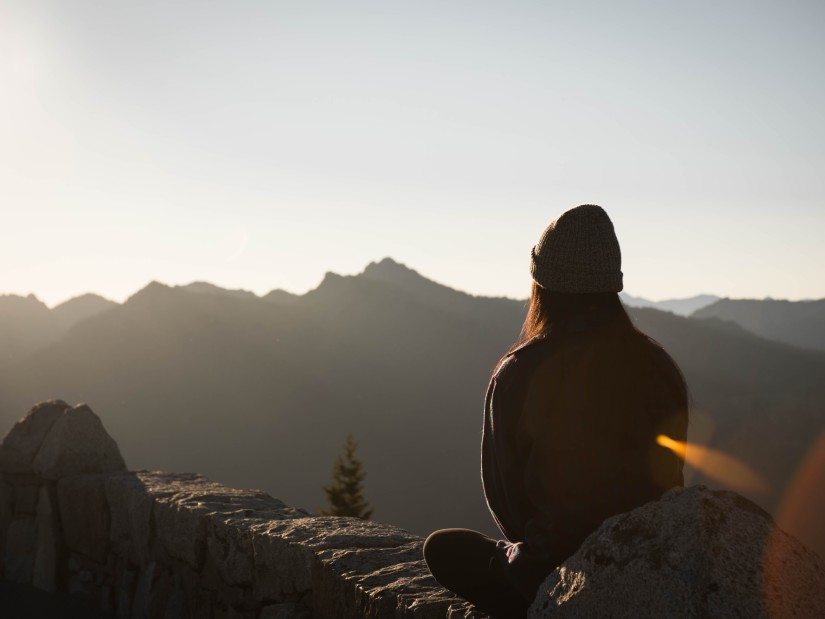 Image of a woman meditating in an open space