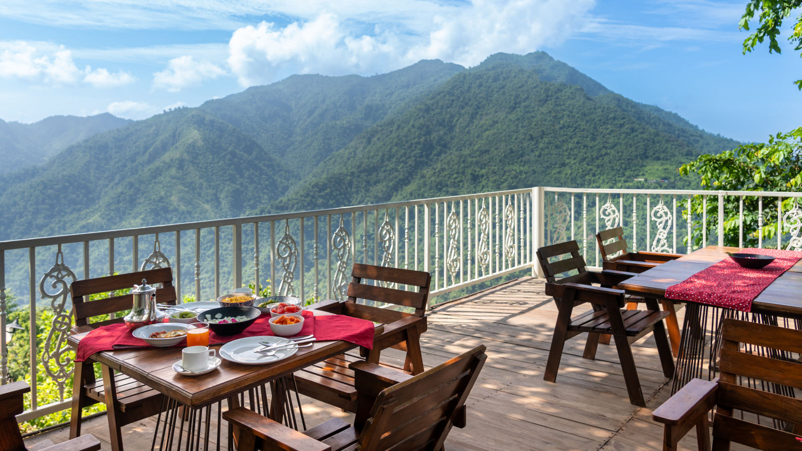 alfresco seating area with mountain view in the background - neer ganga resorts