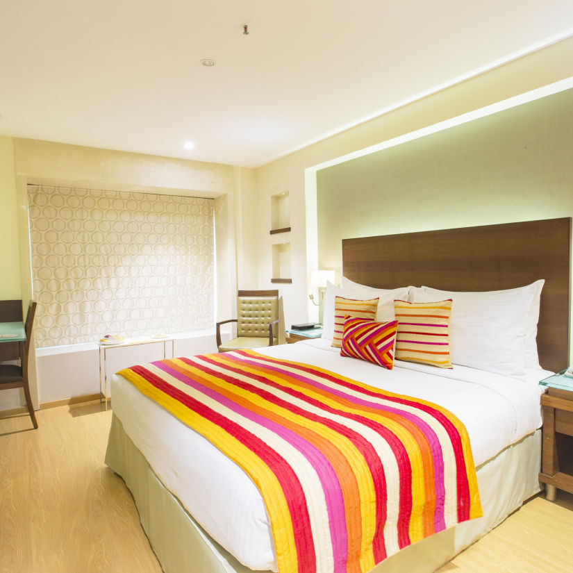 room with king size bed and wooden furnishing at hotel bawa continental