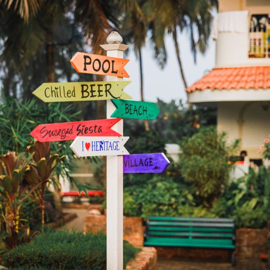 signboard with pool, chilled beer and beach at a wedding in goa